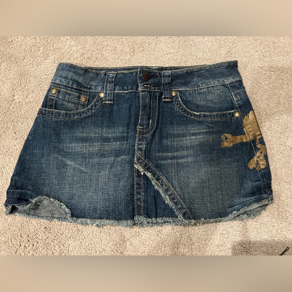 Hydraulic Jean skirt with skull detail on side.